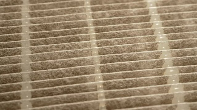 HEPA air filter to stop spread of dust particles floating in the air, dust grains with air pollution and prevent allergy. Macro slow motion view. High efficiency particulate air filter macro close up
