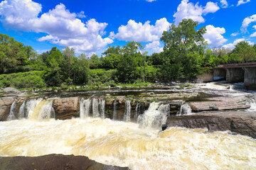 Roaring rapids of the Hogs back waterfall on the Rideau river at the Vincent Massey park in...
