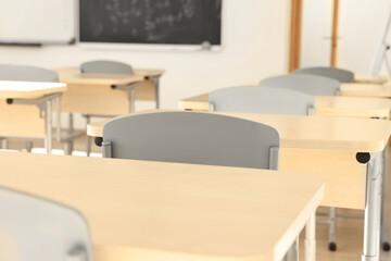 Empty school classroom with desks and chairs