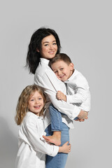 Little children with their mother on white background