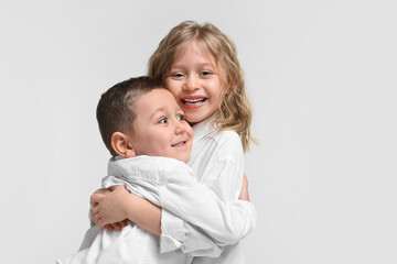 Cute little children hugging on white background. Happy family