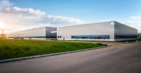 Fototapeta na wymiar Modern Industrial Warehouse at Sunset with Clear Sky