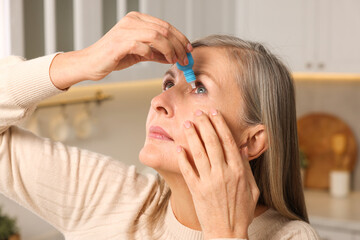 Woman applying medical eye drops at home - obrazy, fototapety, plakaty