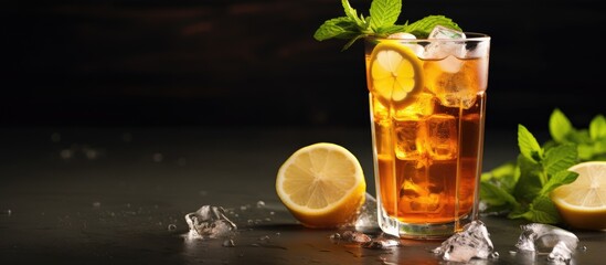 Refreshing Glass of Iced Tea with Lemon and Mint Leaves on a Wooden Table