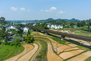 Fototapeta na wymiar Scenic Rural Landscape with Railway Bridge and Fields