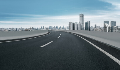 Empty Urban Road Curving Towards Modern Skyline