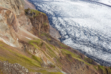 Skaftafel glacier and green cliffs. Southern Iceland landscape. Icelandic background.