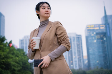 Confident Businesswoman With Coffee in Urban Setting
