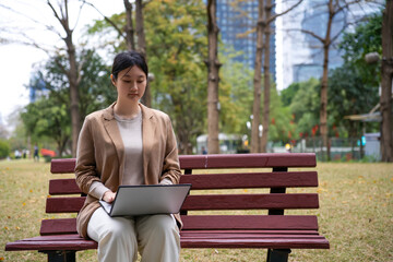 Professional Woman Working on Laptop in Park