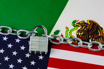 United States and Mexico flags with chain and lock. Border security, immigration reform and illegal...