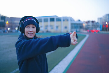 Young Boy with Headphones Giving Thumbs Up Outdoors