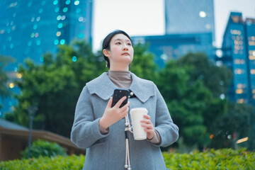 Young Professional Woman Using Smartphone in Urban Park