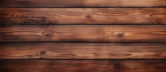 Obraz na płótnie Canvas A closeup of a brown hardwood plank wall with a wood stain and varnish finish. The lumber creates a beautiful pattern with tints and shades in the flooring