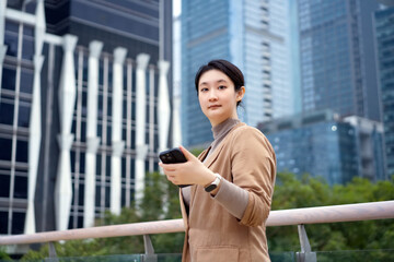 Young Businesswoman with Smartphone in Urban Setting