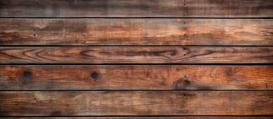 A closeup image showcasing a beautiful hardwood wall with a brown wood stain, creating a captivating pattern of rectangles resembling brickwork, set against a blurred background - obrazy, fototapety, plakaty