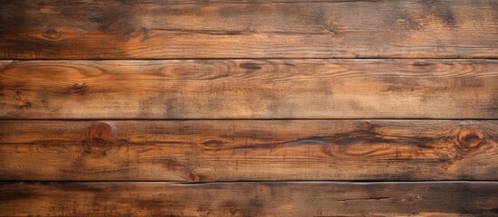 A closeup of a brown hardwood plank wall with a beautiful wood stain pattern. The blurred background enhances the natural beauty of the wood