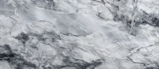 A close up of a grey bedrock formation resembling a marble texture, with swirling patterns of grey and black resembling a frozen landscape under cumulus clouds