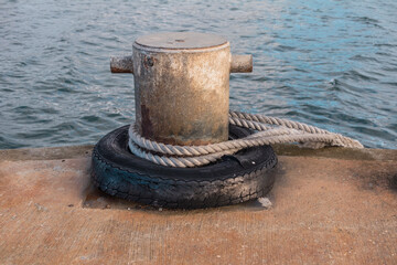 Photograph of white rope wrapped around a steel boat mooring bollard on King Island in the Bass...