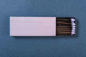 top view lilac matchbox on a blue background at horizontal composition