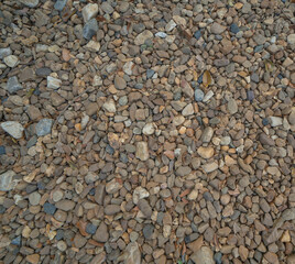 Granite gravel stone rocks flooring pattern surface texture. Close-up of exterior material for design decoration background. Rubble