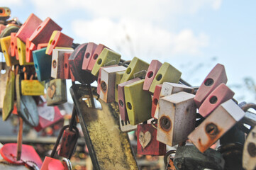 Stack group of keypads for forever love promises in various colours locked together on stairway in Seoul, South Korea
