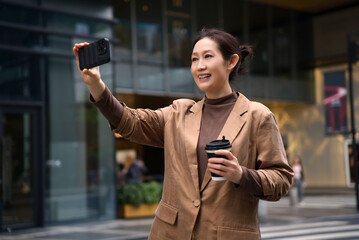 Businesswoman Enjoying Coffee Break with Selfie