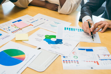 Group of marketing professionals having a meeting. Creative business team brainstorming with sticky notes. Happy business people putting their ideas together as they plan a project.