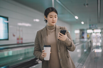 Professional Woman Checking Phone at Airport Terminal