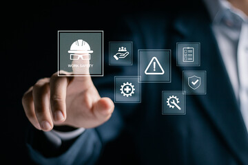 Work safety concept. regulations and standard in industry. Businessman touching safety icon on virtual screen for working standard process and zero accidents.