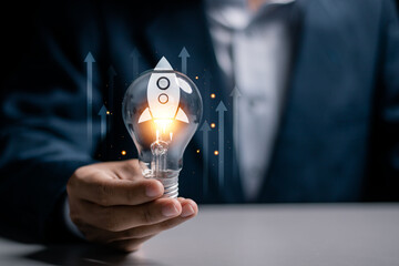 Startup business concept, Strategic planning and business success. Businessman holding light bulb...
