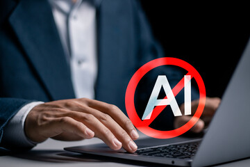 Businessman use laptop with No AI symbol on virtual screen for Stop AI.