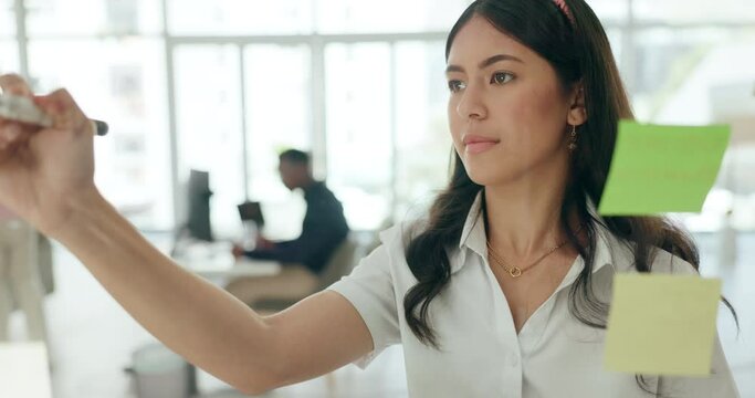 Girl, office and glass for brainstorming idea for presentation, thinking or planning for project and innovation. Female business employee, sticky notes and writing or working on strategy for company.