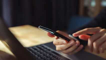 Fototapeta premium The business manager uses a smartphone and its apps for customer support, including email, chat, and phone communication.