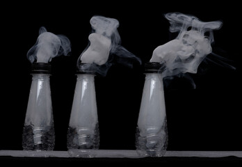 Plastic bottle with fog spraying from top creating strange effects shapes and textures