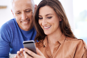 Couple, phone and smile in home to relax with reading, search and mobile app for contact with bonding. People, woman and mature man on smartphone for notification, typing and web connection in house