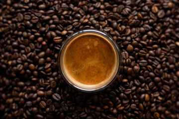 Coffee cup and coffee beans background. Top view with copy space.