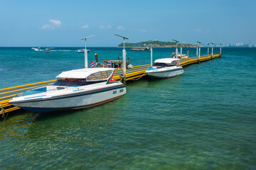 Naklejka na ściany i meble Speed boats at Na Ban pier at island of Kohlarn, Thailand. Boats take tourists to the Koh Larn island from Pattaya, Thailand.