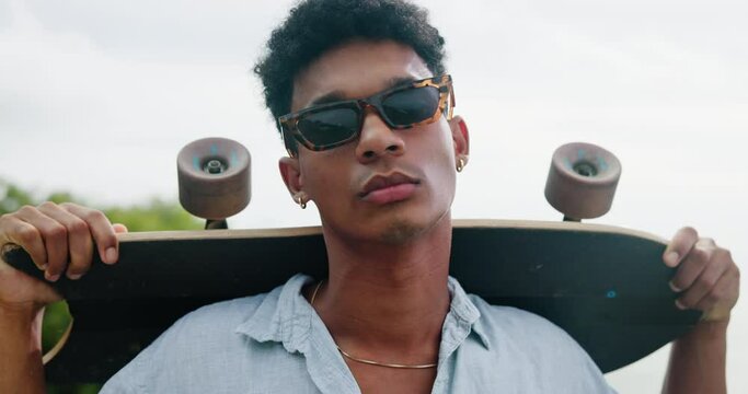 Man, sunglasses and skateboard with confidence outdoor for fashion, protection from sun or vision. Stylish, trendy and edgy, shades for summer with accessory or eyewear for cool skater with travel