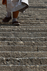 the steps of a Chinese temple monk up the stairs