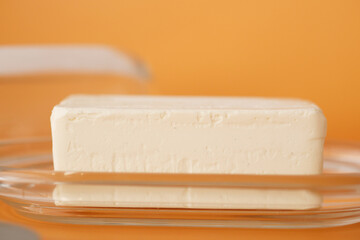 slice of a butter on a paper on table 