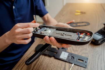 A technician assembles and installs smart electronic door lock for house protection
