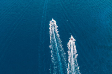 Top aerial view of pair two boat sailing to the blue sea. Drone view of a boat sailing...