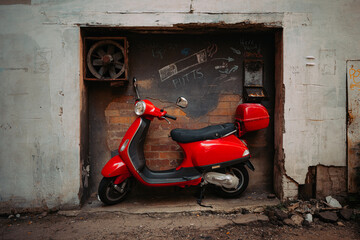Fototapeta premium Red Scooter parked in grungy laneway