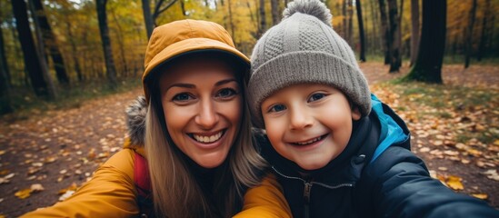 A Mother and Her Child Capturing Joyful Moments with a Selfie - obrazy, fototapety, plakaty