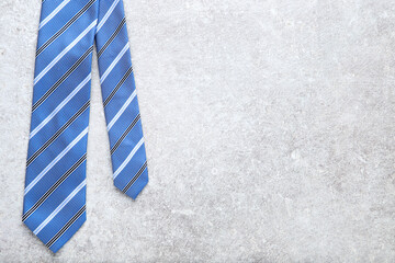 Striped necktie on grey background