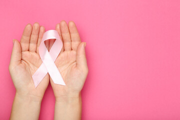 Breast cancer concept. Female hands holding pink ribbon - 760327607