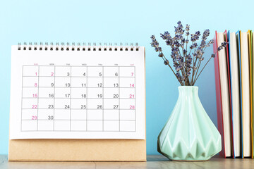 Calendar page with lavender flowers and notepads on blue background