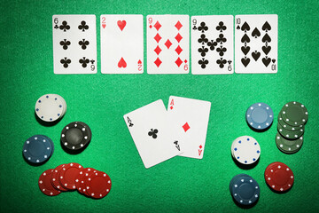 Poker chips and cards on green table - 760328299