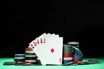 Poker chips and cards on green table - 760328456