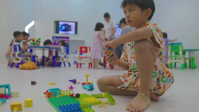 Adorable little boy and girl enjoying play toy block building imagin education learnning